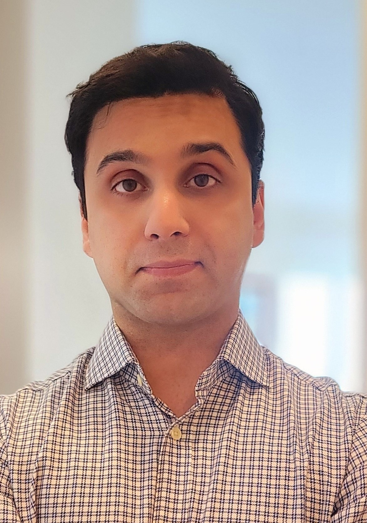 Reza Boostani - Product Manager and Technical Builder based in Toronto, specializing in EV charging and sustainable technology. Professional headshot of Reza Boostani.