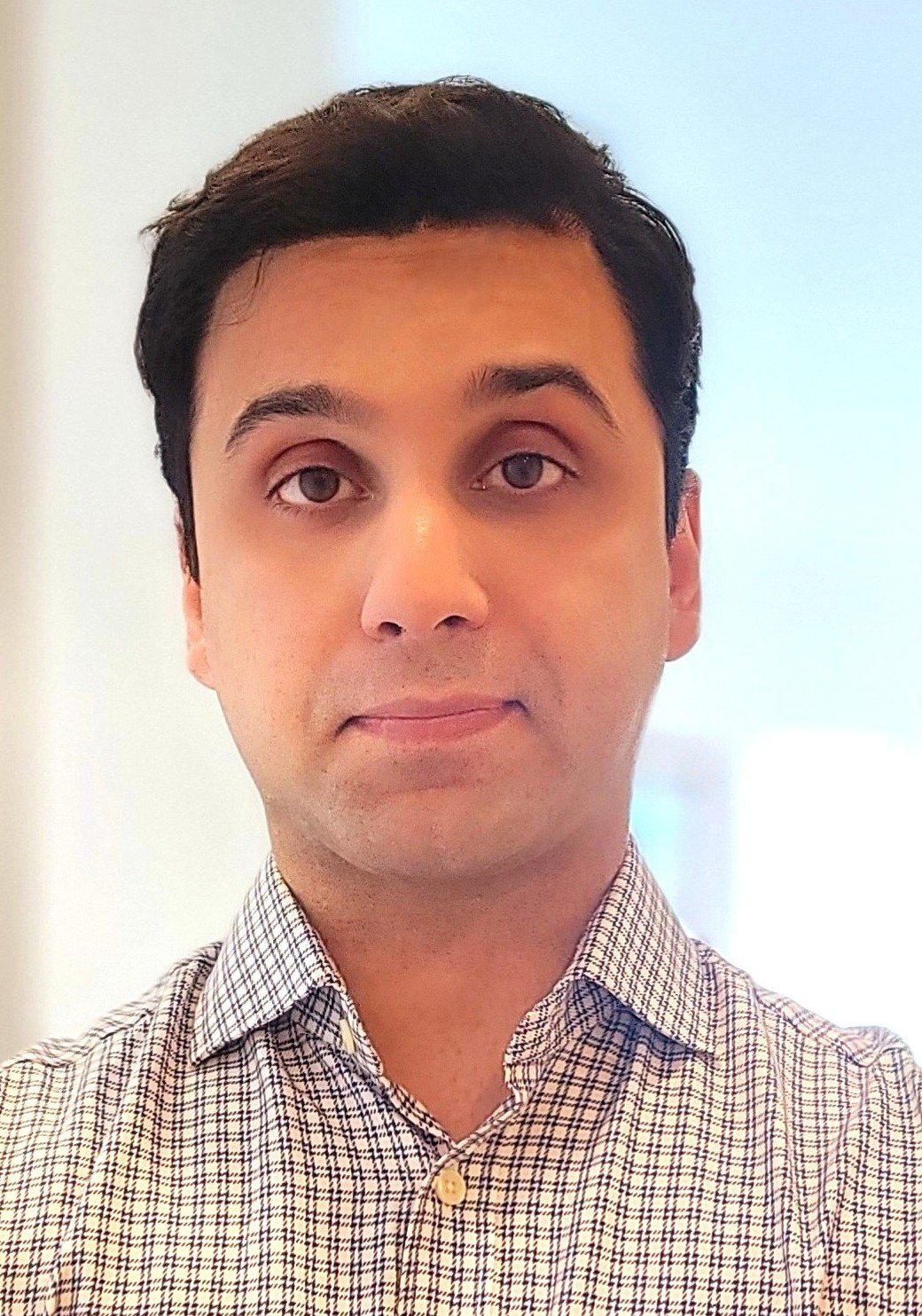 Reza Boostani - Product Manager and Technical Builder based in Toronto, specializing in EV charging and sustainable technology. Professional headshot of Reza Boostani.